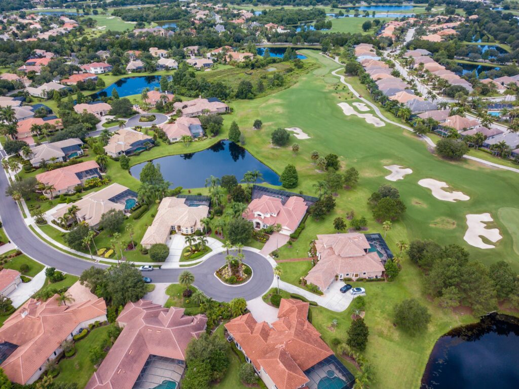 A view of houses and golf course from above.