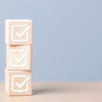 Three wooden blocks with checkmarks.